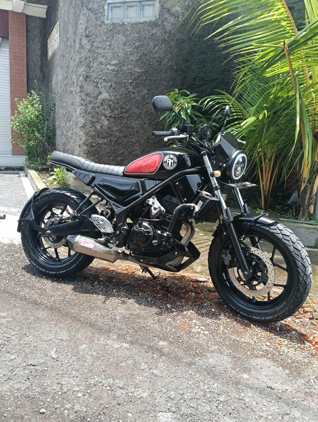 Black Kawasaki cafe racer with red tank detail